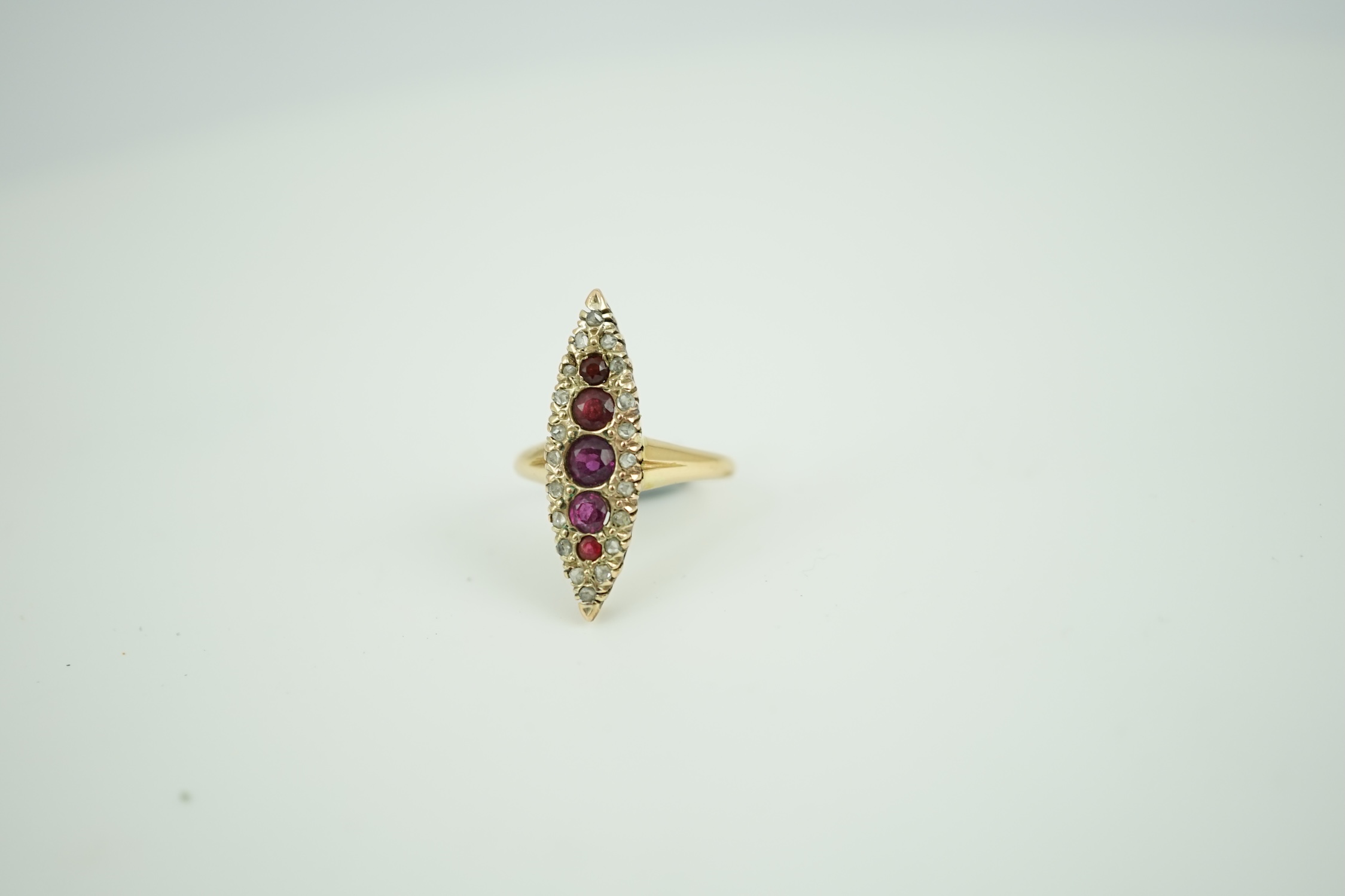 A late Victorian 18ct gold, ruby? and diamond marquise cluster set ring, size L, gross weight 3.5 grams.